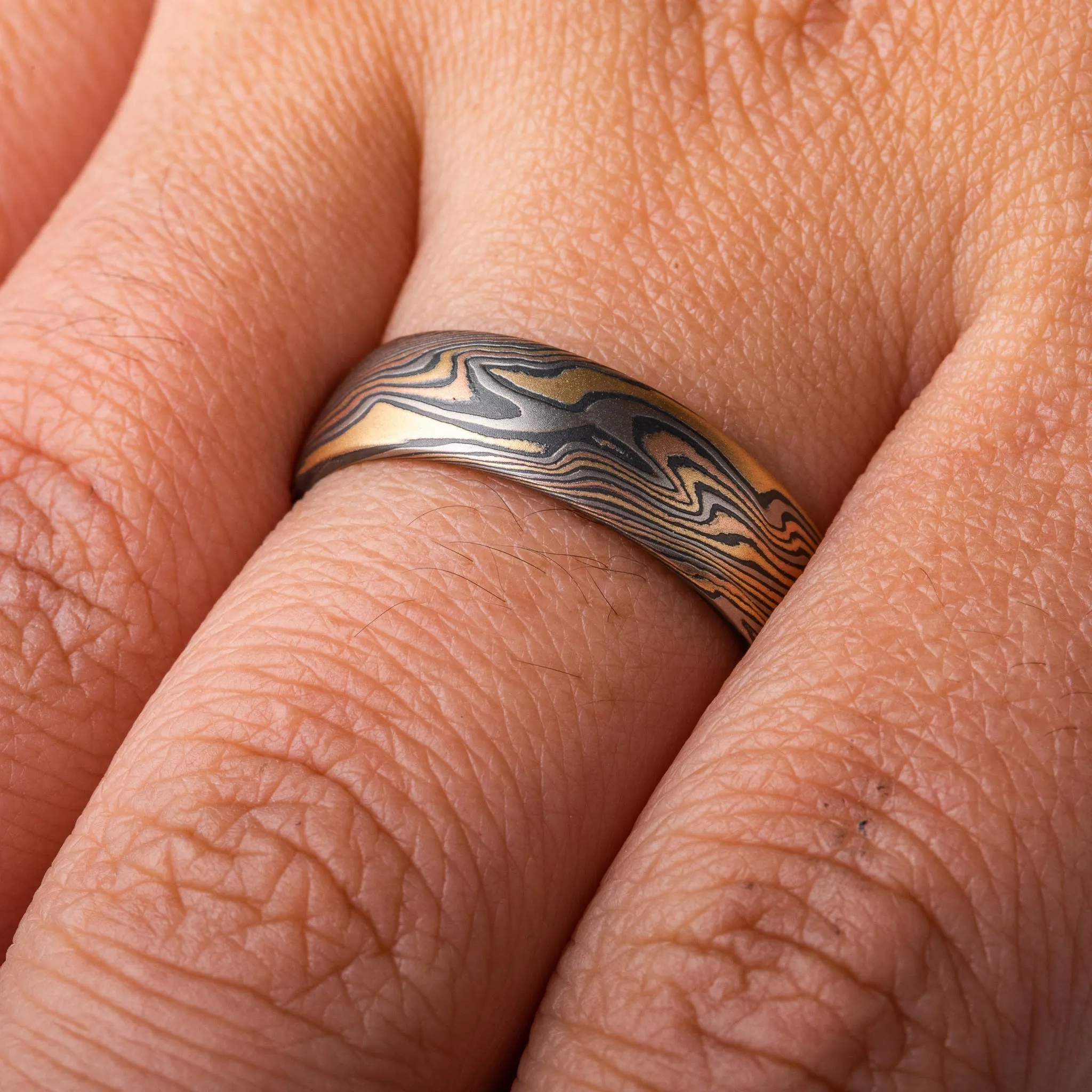 Woodsy Mokume Gane Ring Set in Firestorm Palette and Twist Pattern with Montana Sapphire