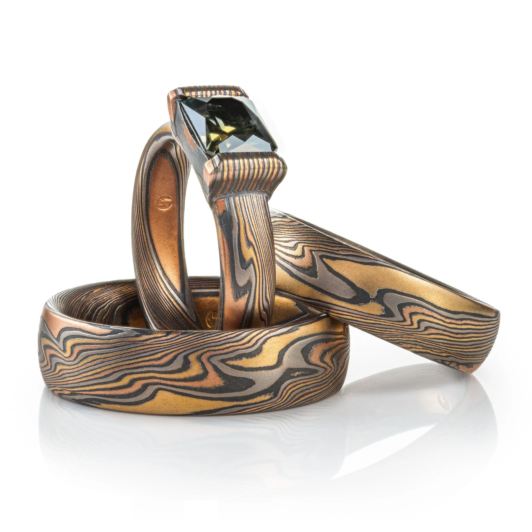 Woodsy Mokume Gane Ring Set in Firestorm Palette and Twist Pattern with Montana Sapphire