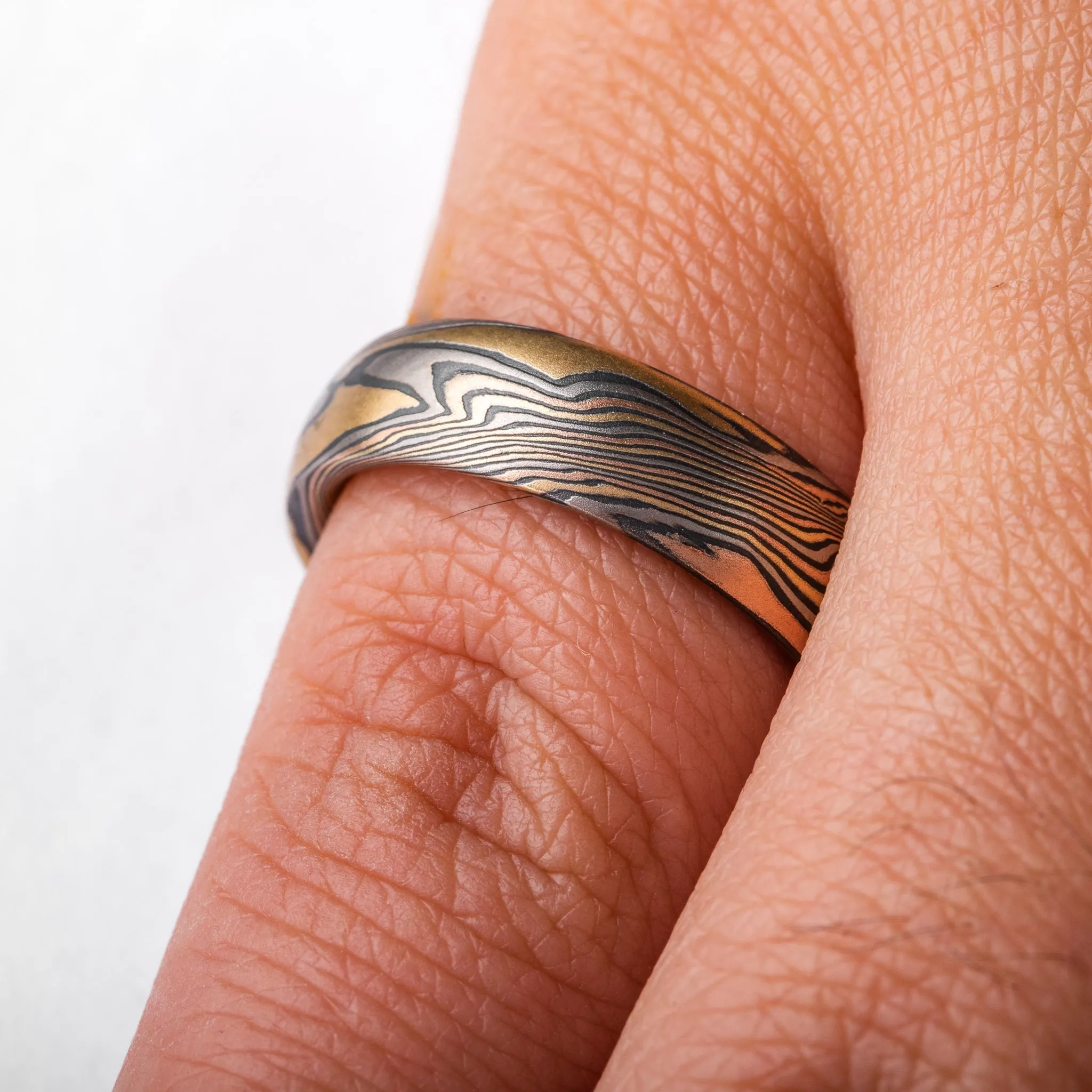 Woodsy Mokume Gane Ring Set in Firestorm Palette and Twist Pattern with Montana Sapphire